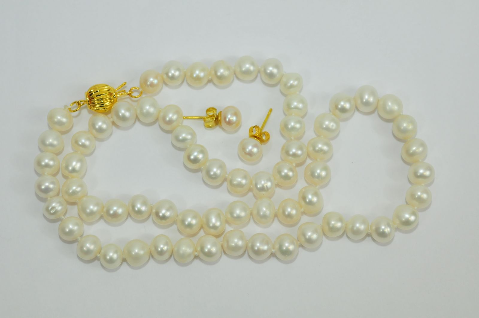 A white Akoya cultured pearl necklace and earring set.