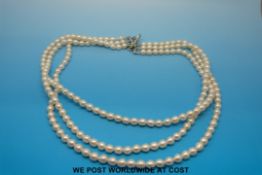 Triple string pearl necklace