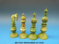 Four Indian Vizagapatam elaborately carved stained green ivory chess pieces (largest piece 11cm)