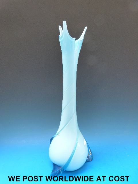 A tall modern blue glazed vase with swirl decoration