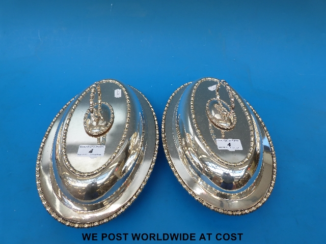 Two plated and lidded servers