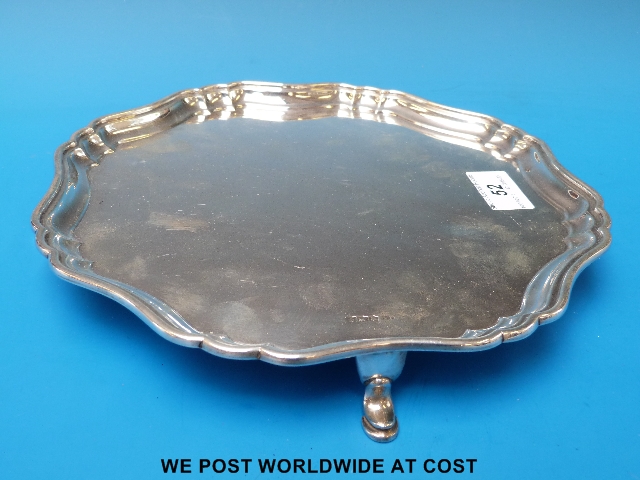 A silver un-engraved gadrooned salver raised on four hooved feet (B'ham 1924) approx 536 g approx