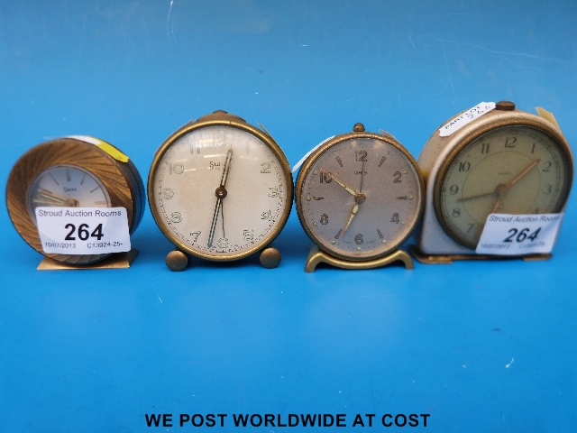Four miniature vintage alarm clocks, two Swiza, an Oris and a Smiths