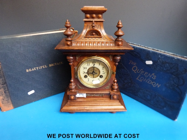 A mantel clock together with "The Queen's London" and "Beautiful Britain"