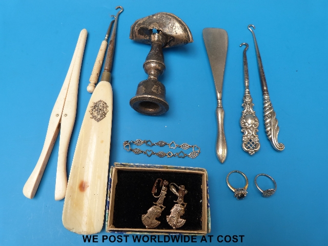 A collection of silver to include button hooks, shoe horn, bracelet, ivory glove stretcher etc.