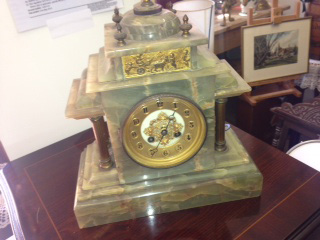 A late 19th century French gilt metal mounted green onyx mantel clock of classical architectural
