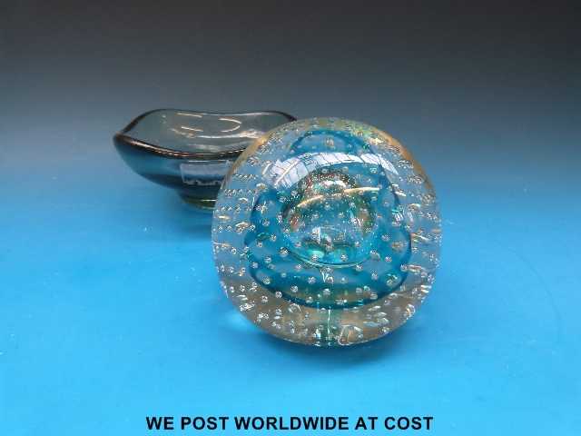 A very large glass paper weight with teardrop central bubble surrounded by multiple bubbles with a