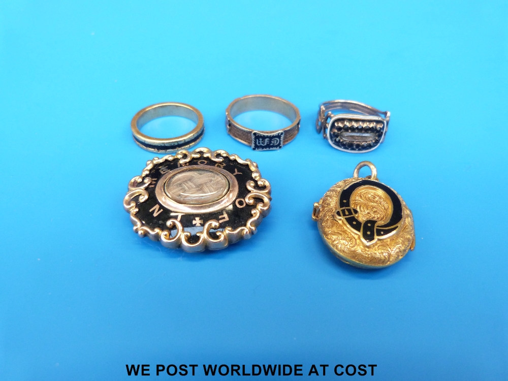 Five pieces of mourning jewellery including three rings, brooch set with plaited hair and locket