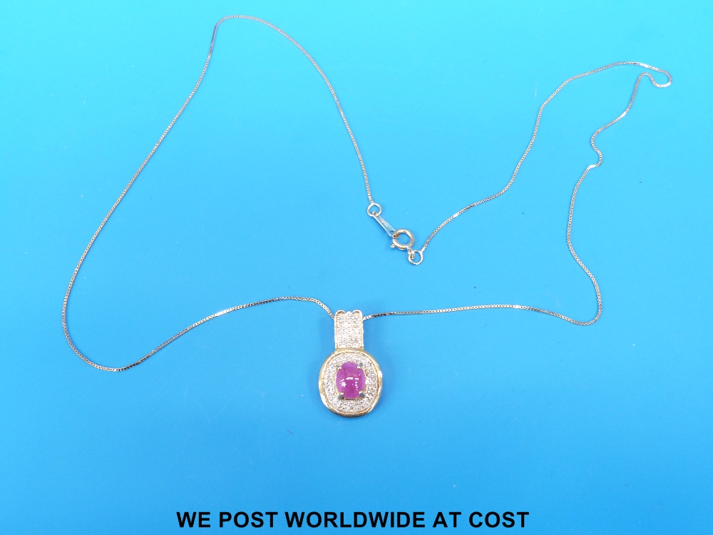 Gem encrusted pendant with central pink stone, 18 ct gold.