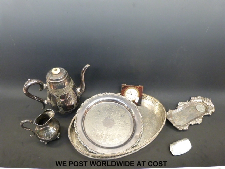 A collection of plated ware including a tray, hot water pot, travelling eight day clock and