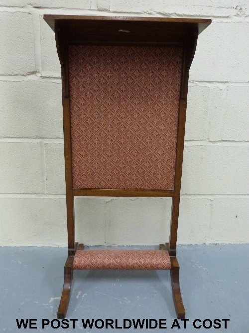 A mahogany fire screen with central pull up section.