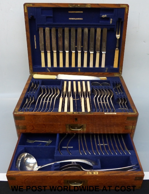 An oak four-section fitted canteen of cutlery by Brook and Son, Goldsmiths to the King, Queen