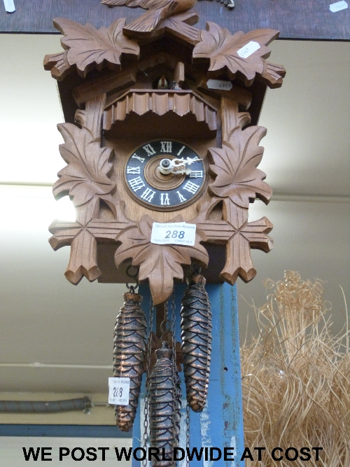 Three-train musical cuckoo clock complete with weights and automoton movement