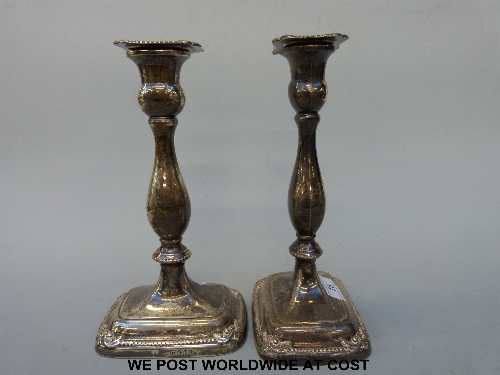A pair of William IV hallmarked silver candlesticks, with bead and scrolling decoration, height