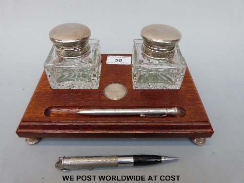 A hallmarked silver mounted double inkwell with silver mounted bottles and feet, B'ham maker B &