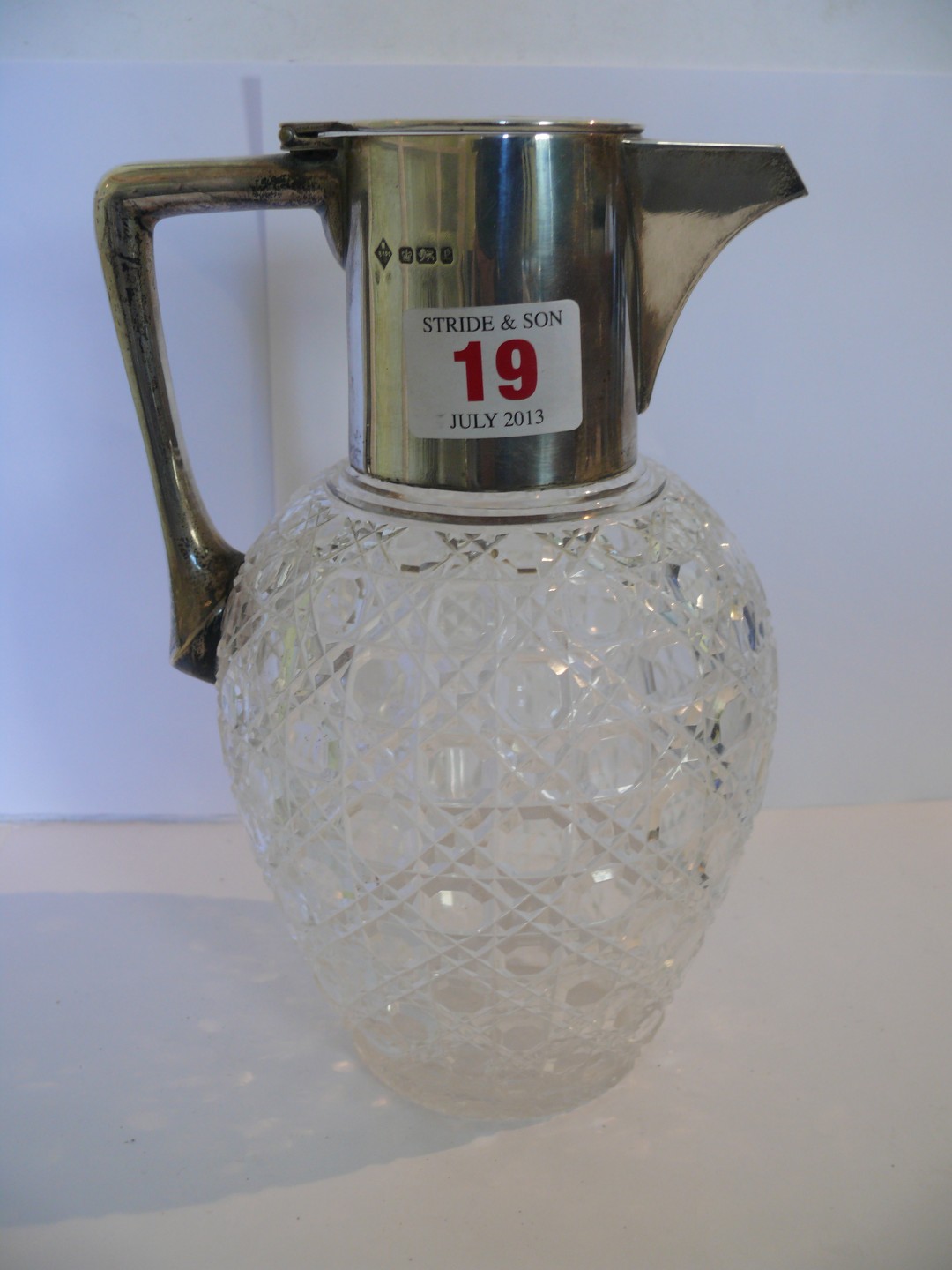 A Victorian hobnail cut glass claret decanter, having silver mount with hinged lid, maker Mappin