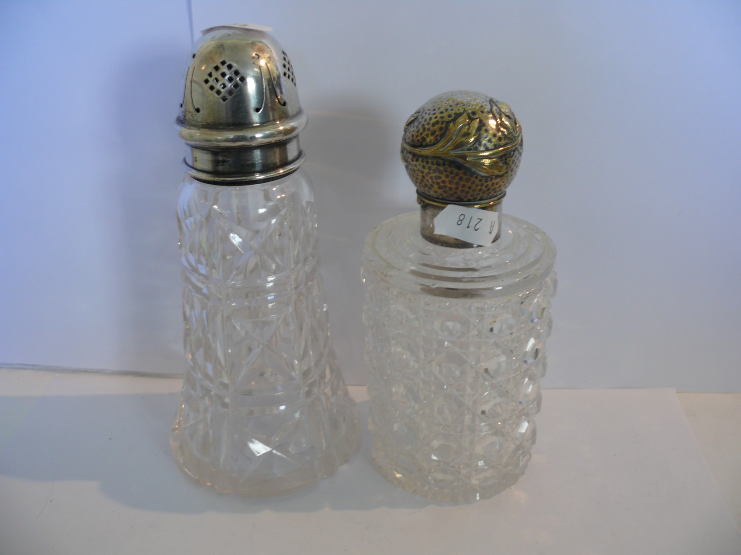 A silver lidded cut glass sugar shaker, by Charles Boyton & Sons, Sheffield 1936; together with a