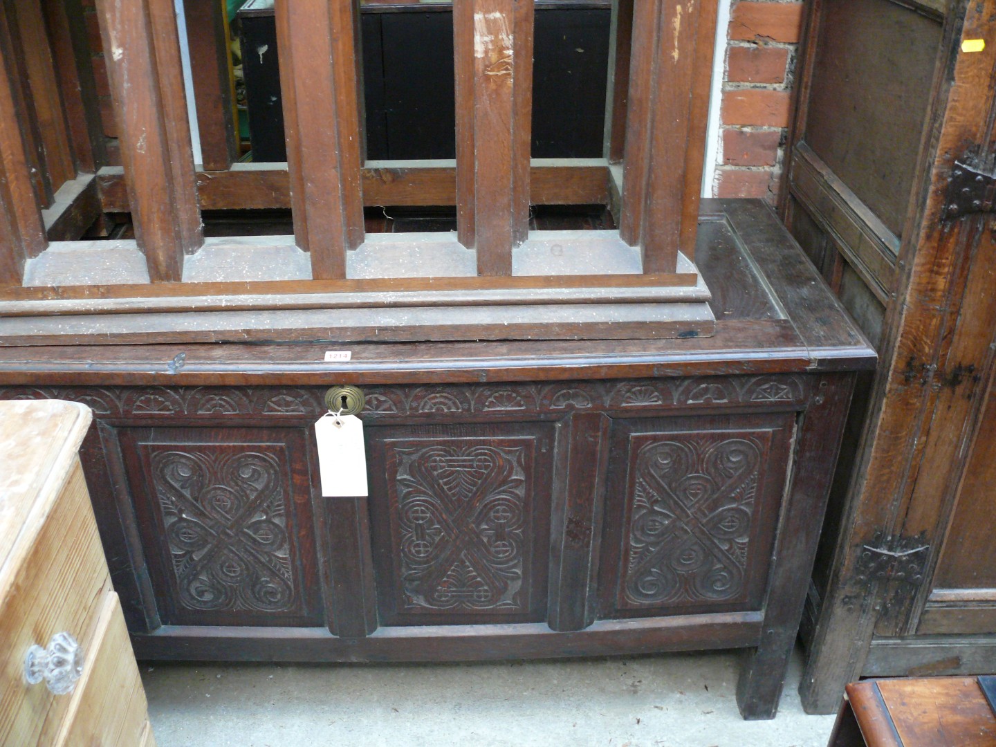 An early 18th century carved oak panelled coffer, 140cm wide.