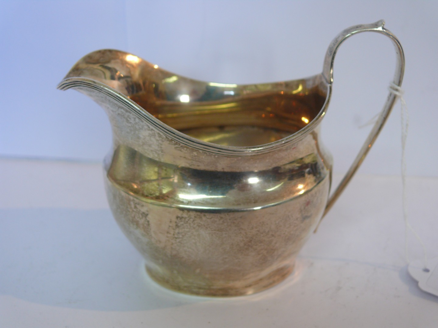 A George III style silver milk jug, maker George Nathan & Ridley Hayes, Chester 1905, 4oz, 9cm