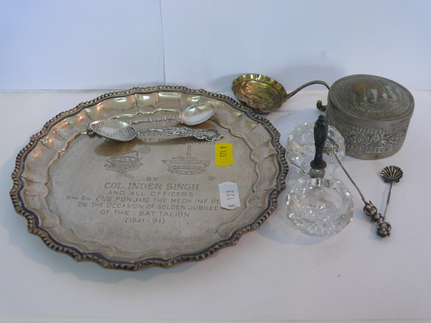 A metal circular waiter engraved presentation; together with a metal box with lid decorated