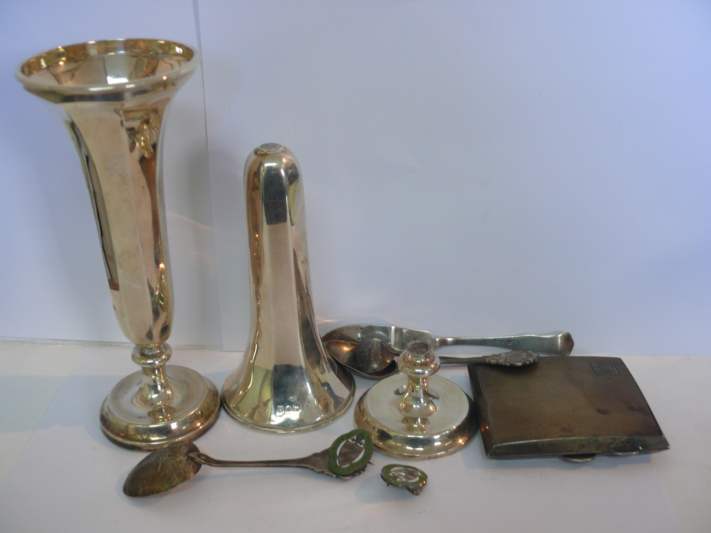 A pair of silver vases by W Comyns, London (one broken at stem); together with a silver cigarette