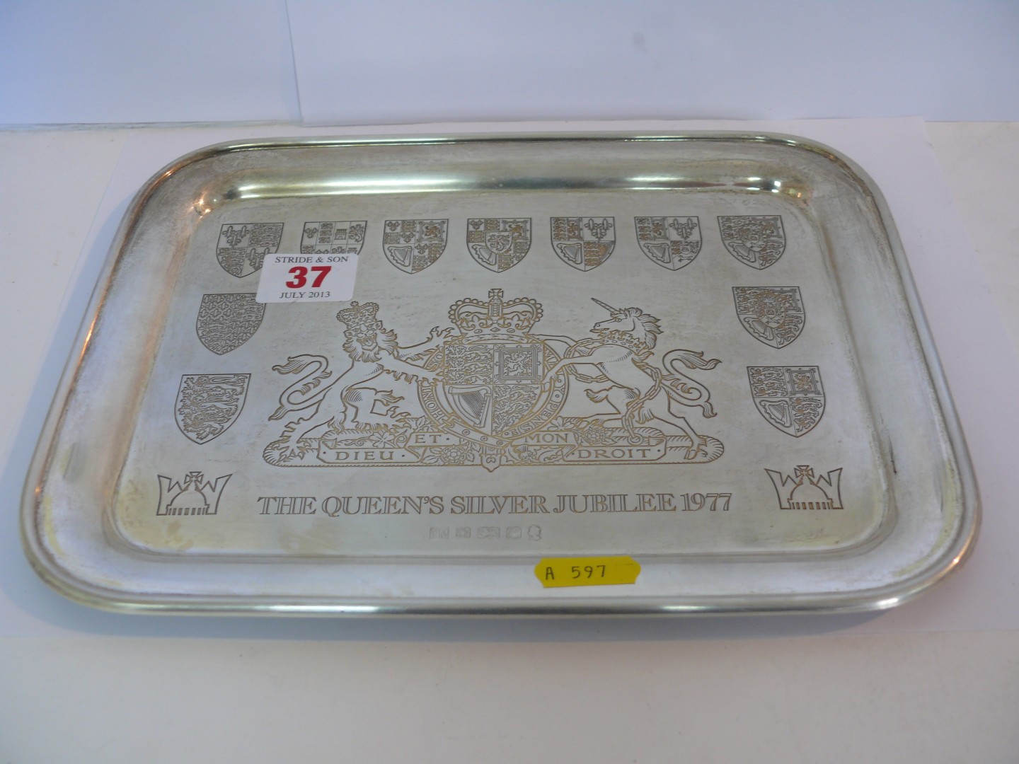 A rectangular silver tray, engraved royal crests to commemorate the Queen`s silver jubilee 1977,