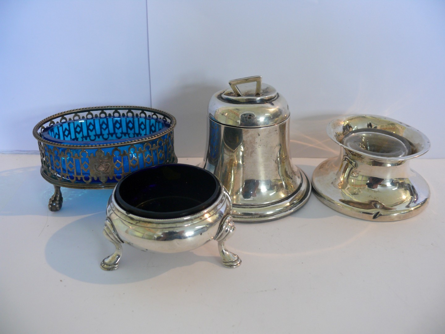 A silver bell shaped inkwell by A J Zimmerman, (dented); together with another inkwell and two