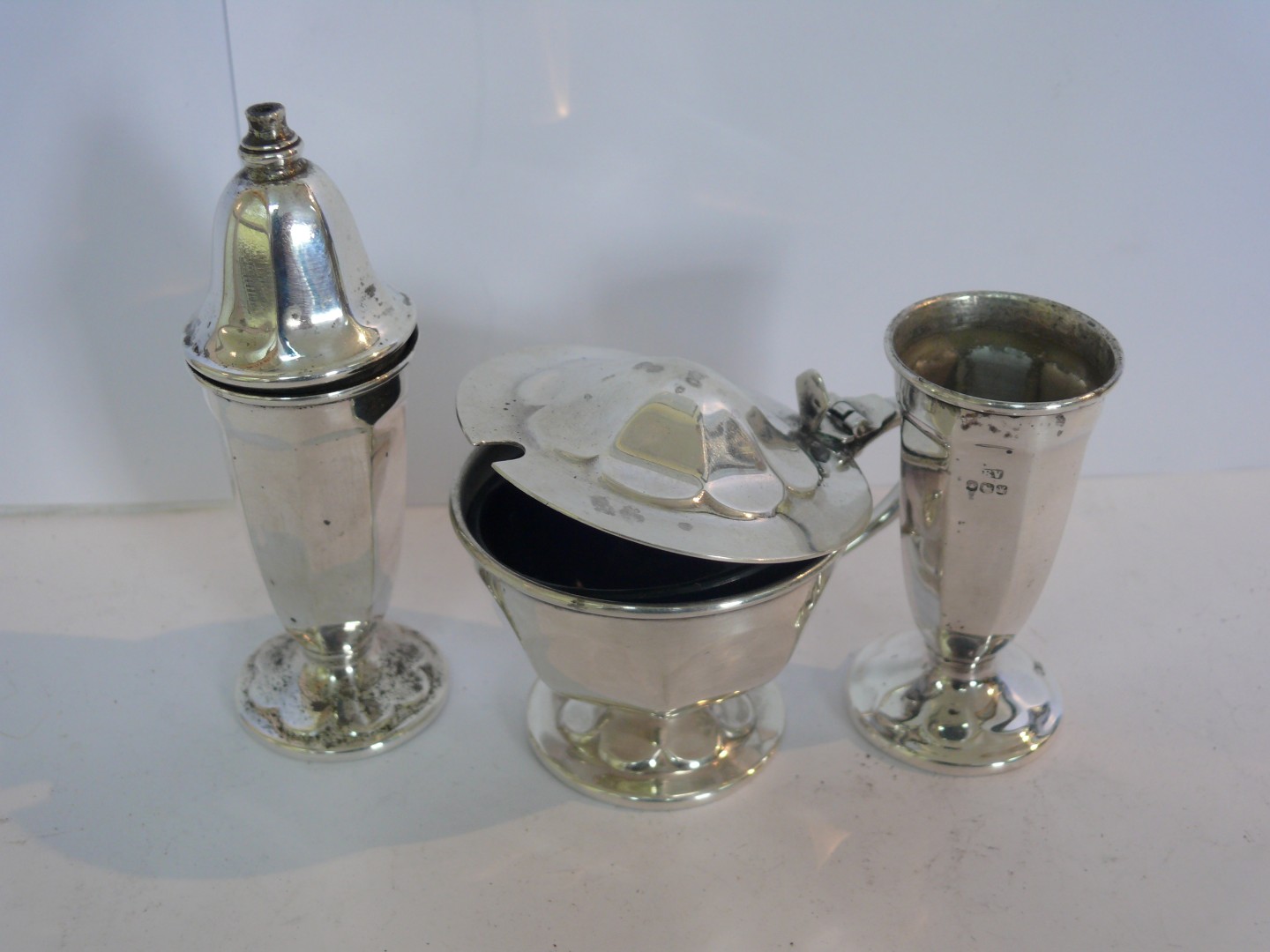 A silver three piece condiment set by E Viner, Sheffield 1966, 5.7oz, salt 10cm tall.