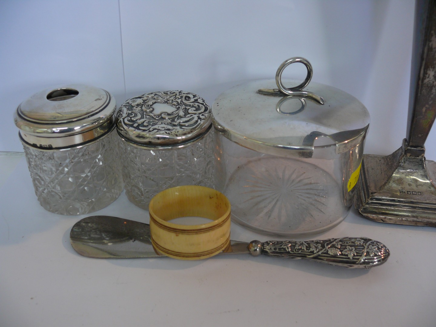 Three various silver lidded glass containers, a silver handled shoehorn, silver flower vase with