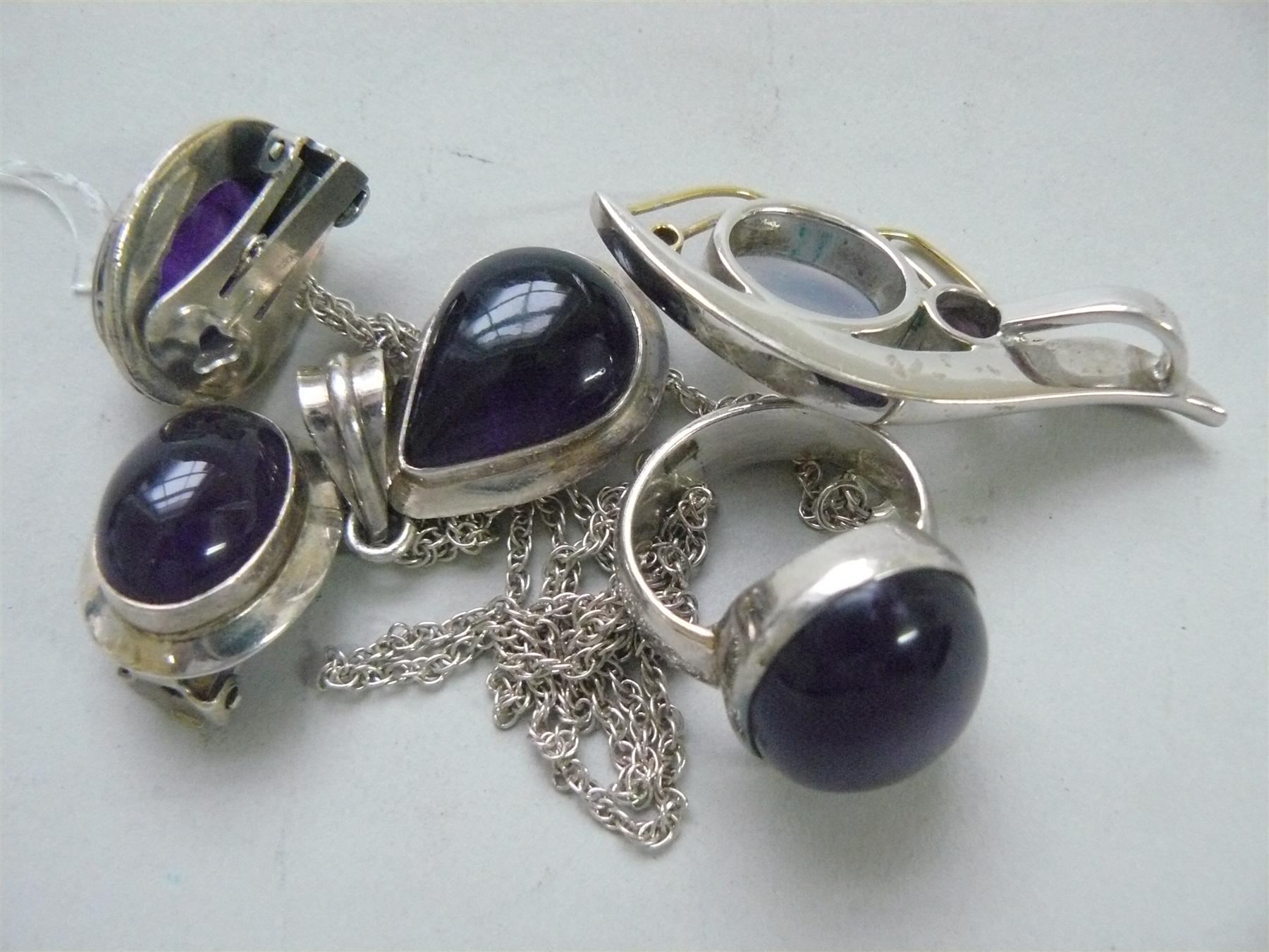 An amethyst set silver ring; together with a pair of amethyst set earclips and pendant; and one