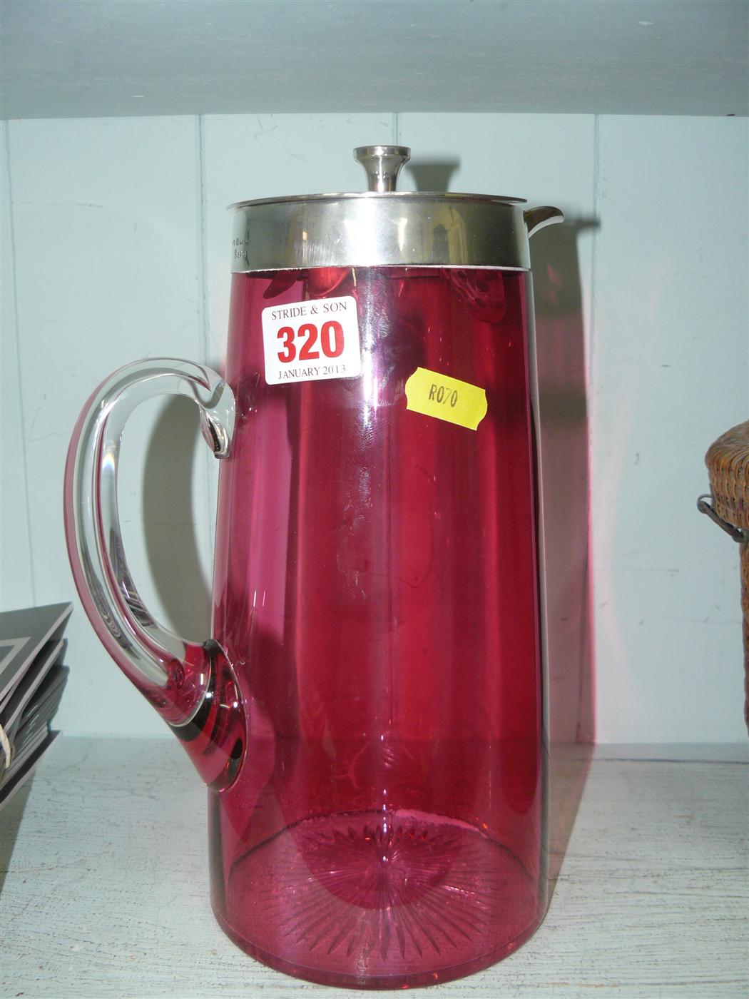 A cranberry and white glass cylindrical lemonade jug, having silver mount to rim by John