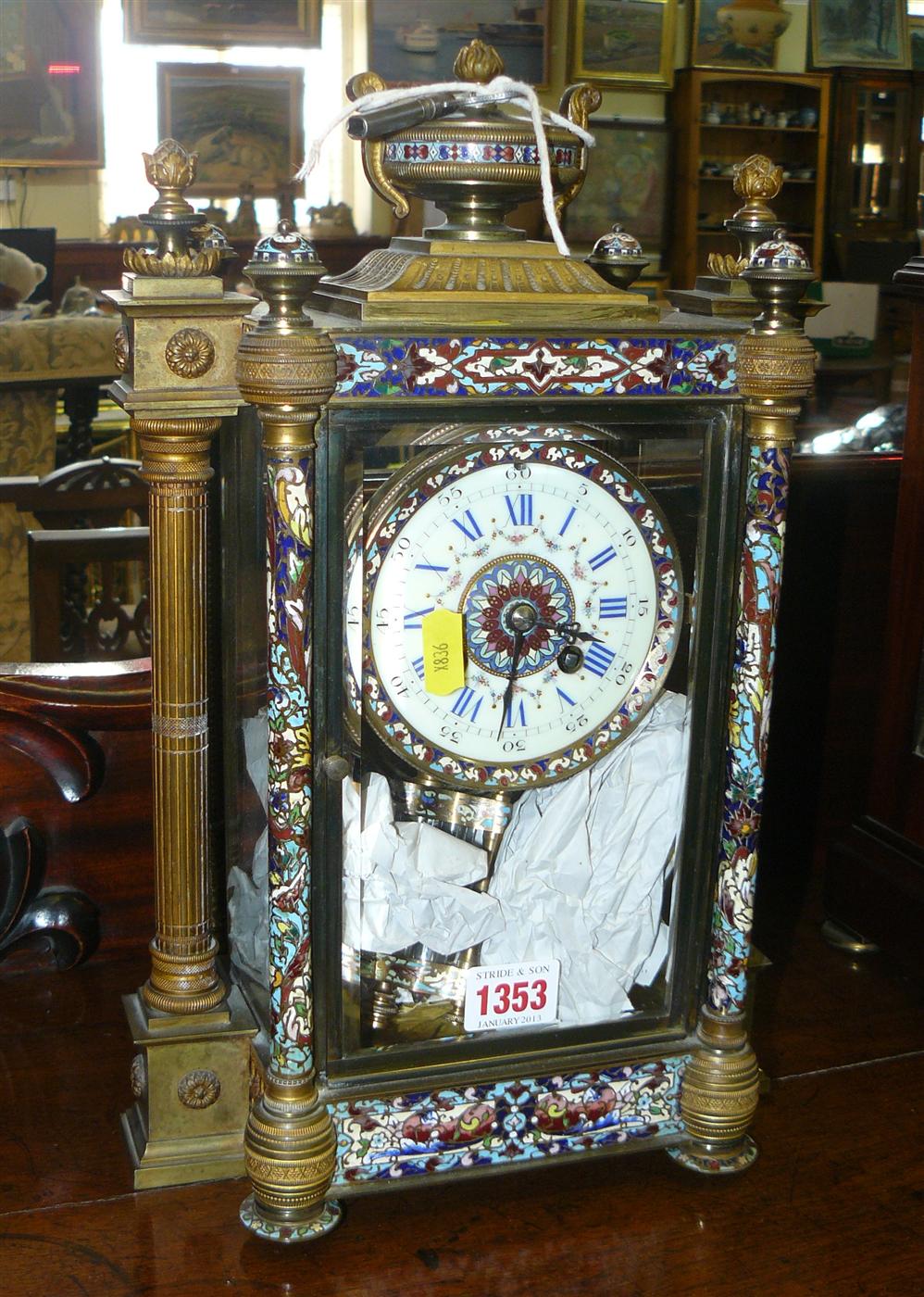 A late 19th century brass and champleve enamel mantel clock, with mercury pendulum, 36cm high.