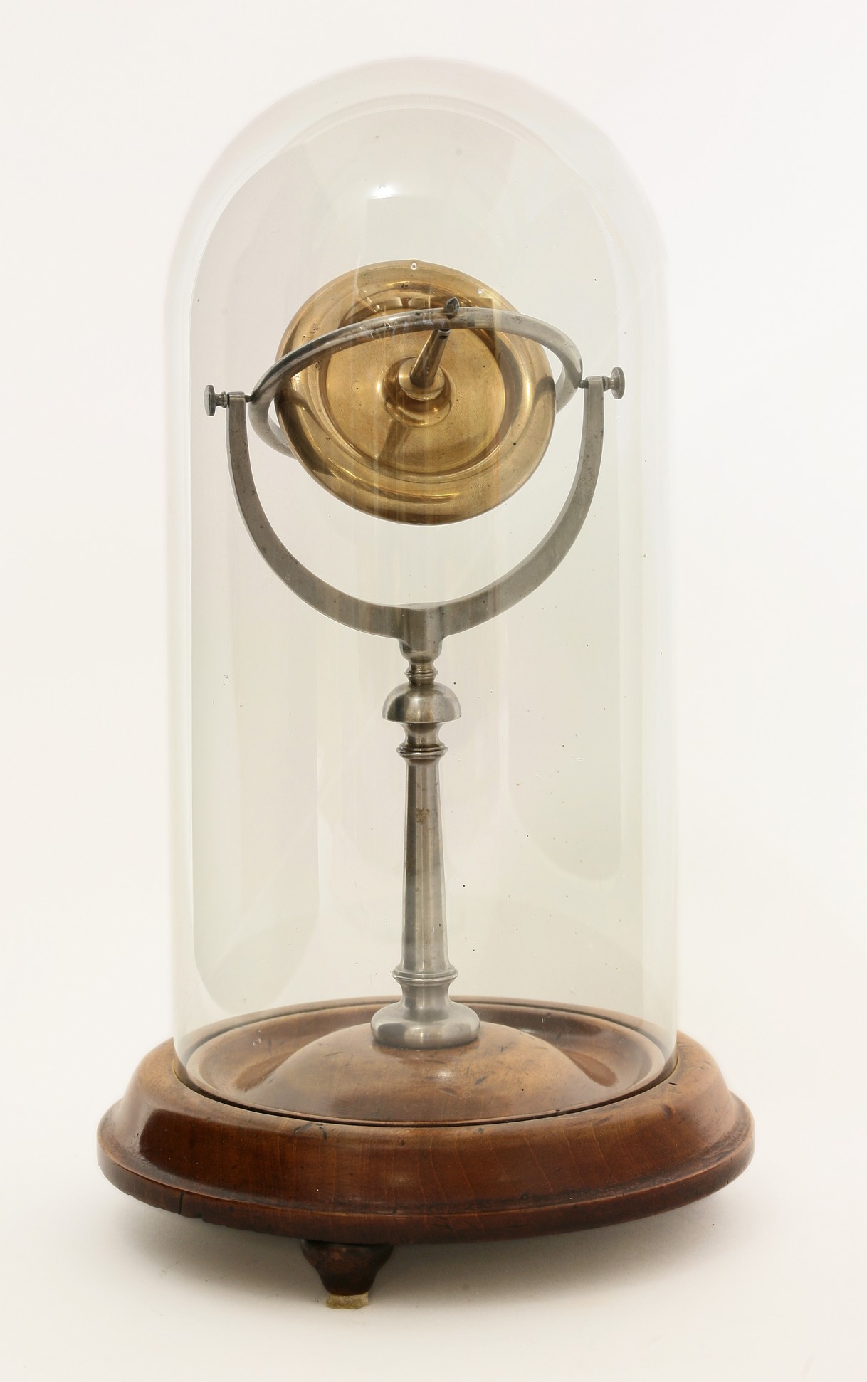 A brass and steel demonstration gyroscope,
19th century, upon a turned walnut base beneath a glass