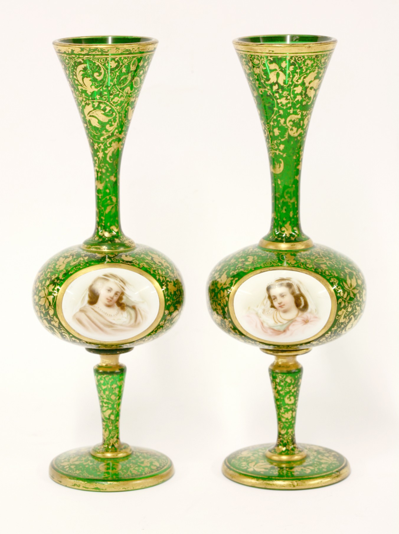 A pair of Bohemian green glass Vases,
c.1870, of slender form with central bellied section applied