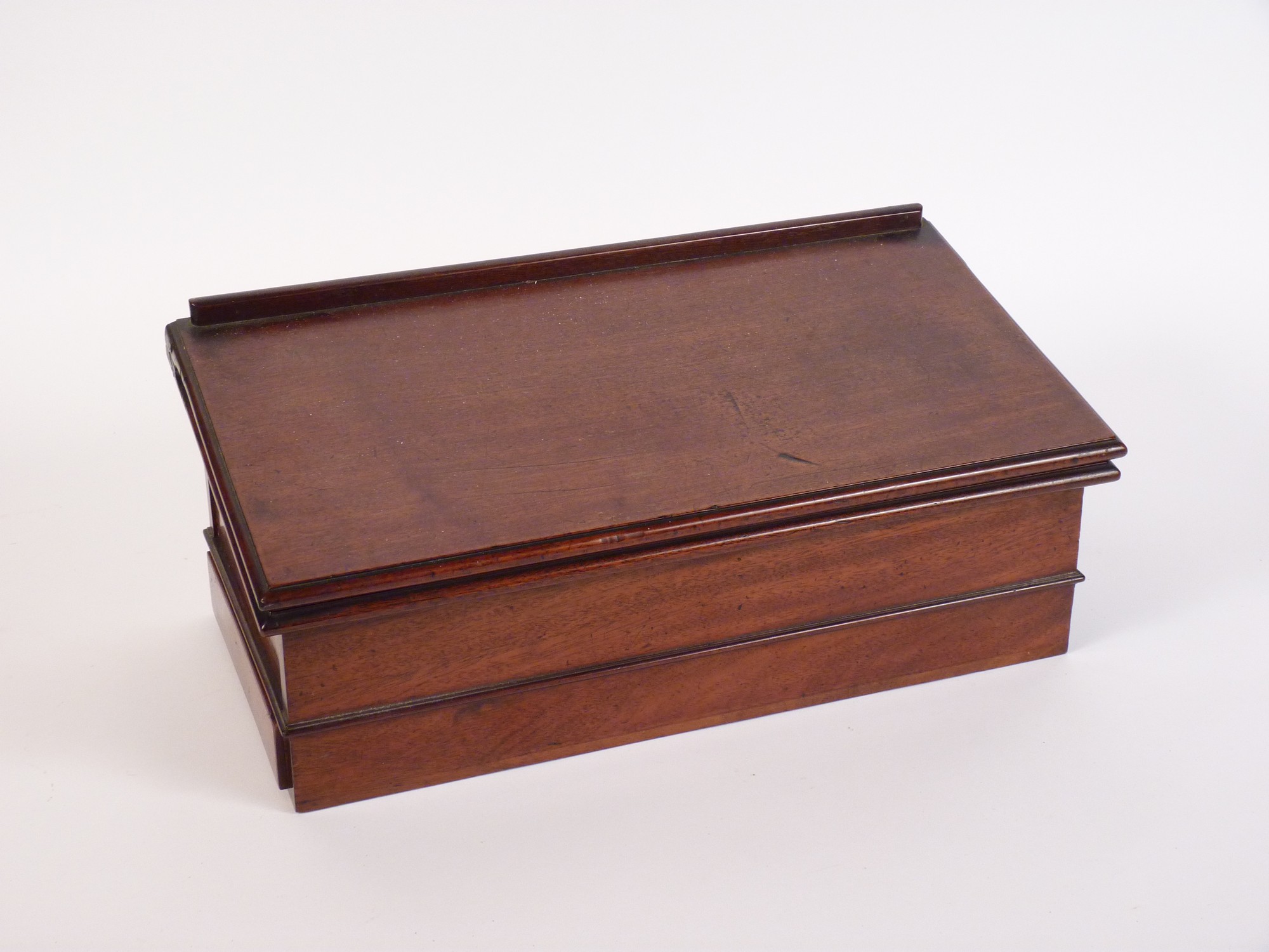 A Chippendale period mahogany campaign desk,
c.1775, the sloping hinged top opening to reveal a