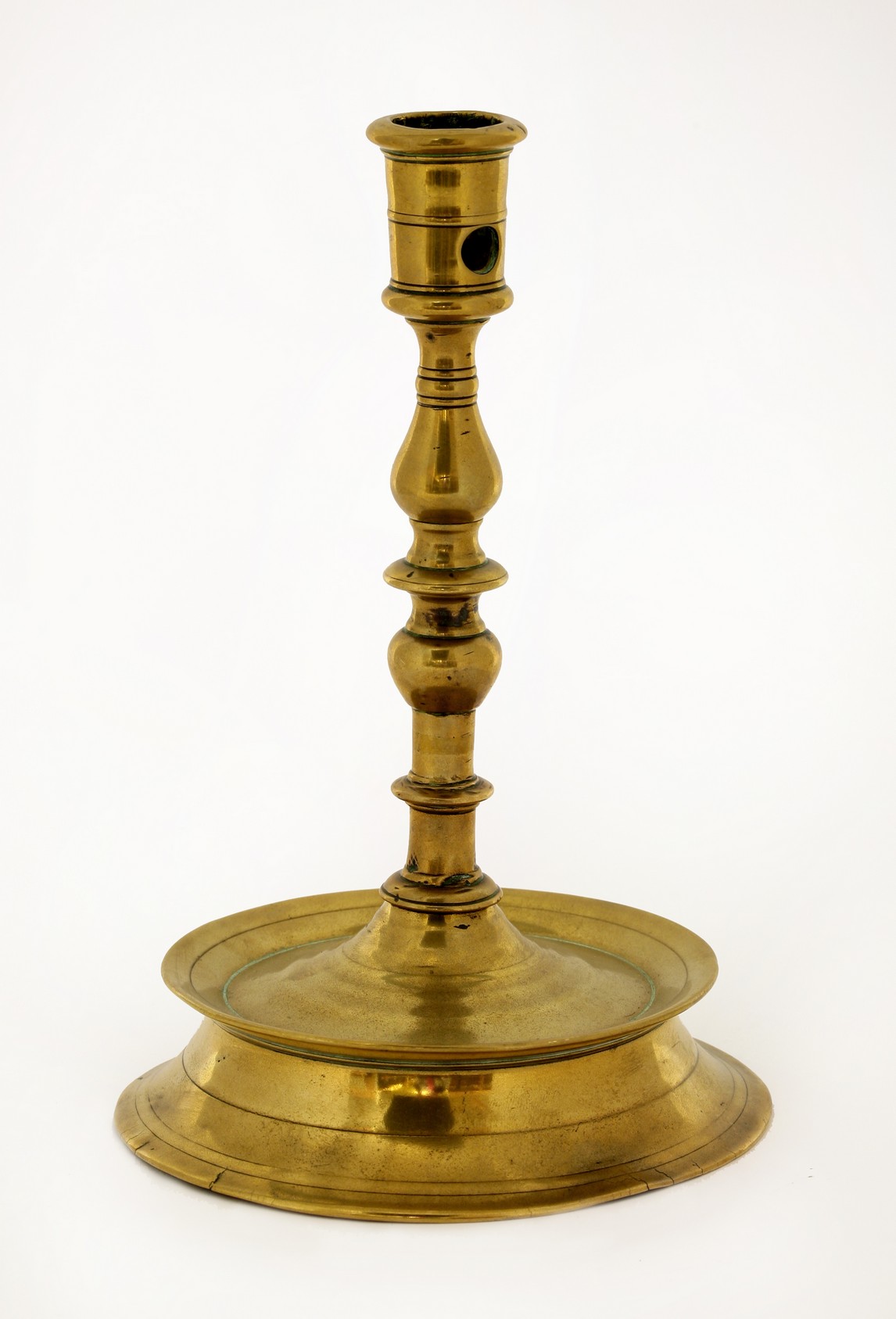 A brass candlestick,
late 17th century, later repaired,
21cm high CONDITION REPORT: The base has