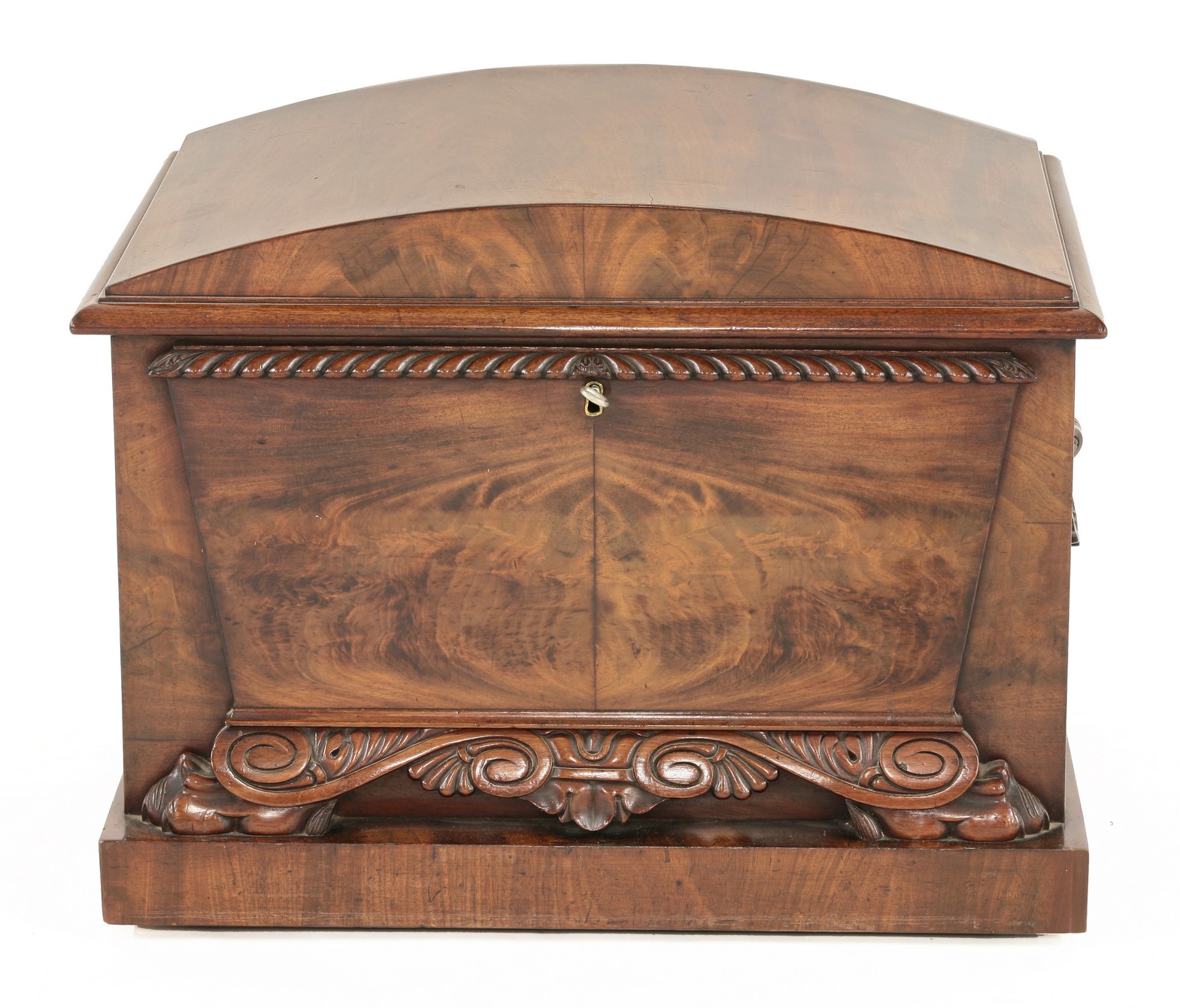A Regency mahogany sarcophagus-shaped cellaret,
with domed cover and shell shaped handles, and a