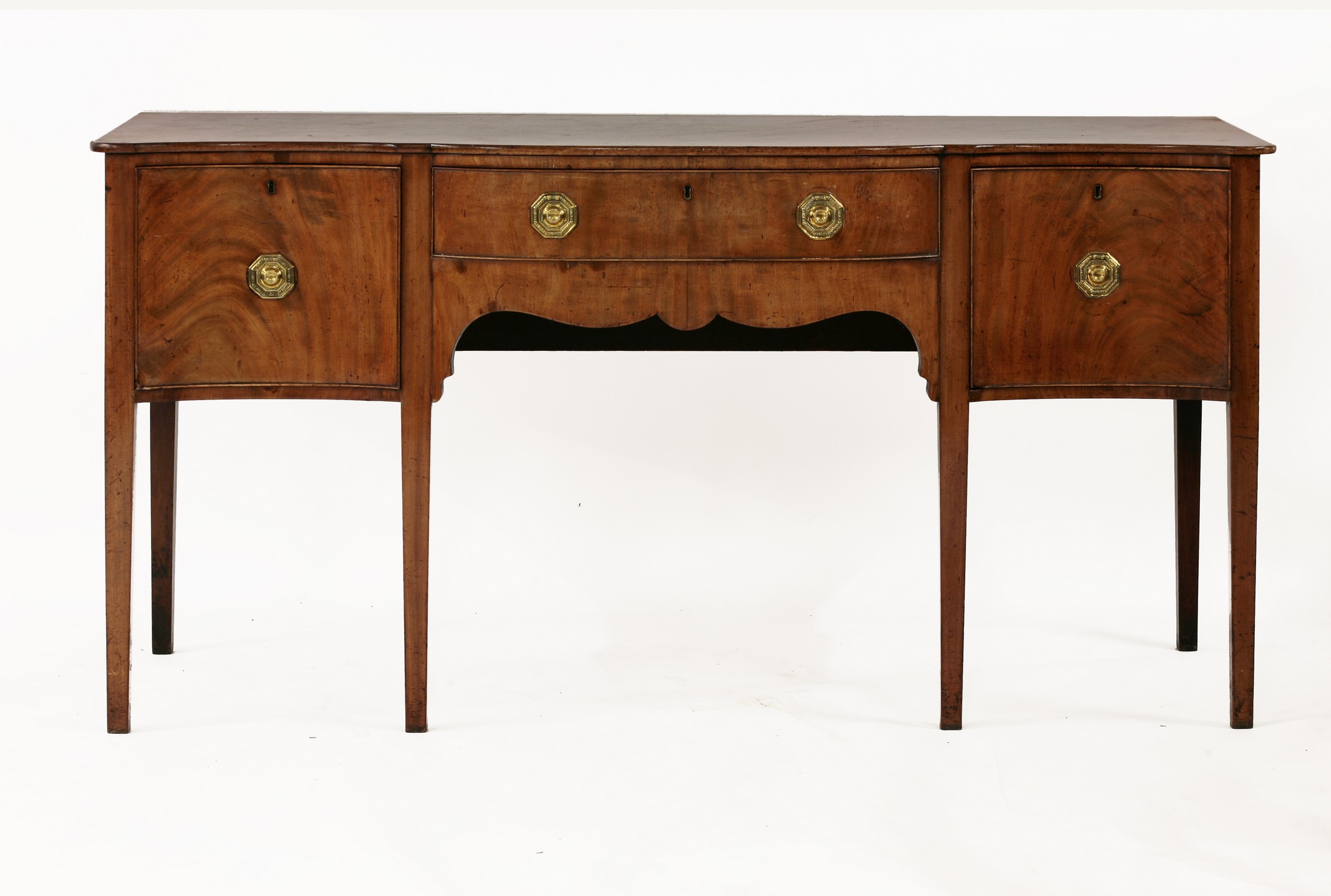 A George III mahogany serpentine fronted sideboard,
with bow front central drawer flanked by two