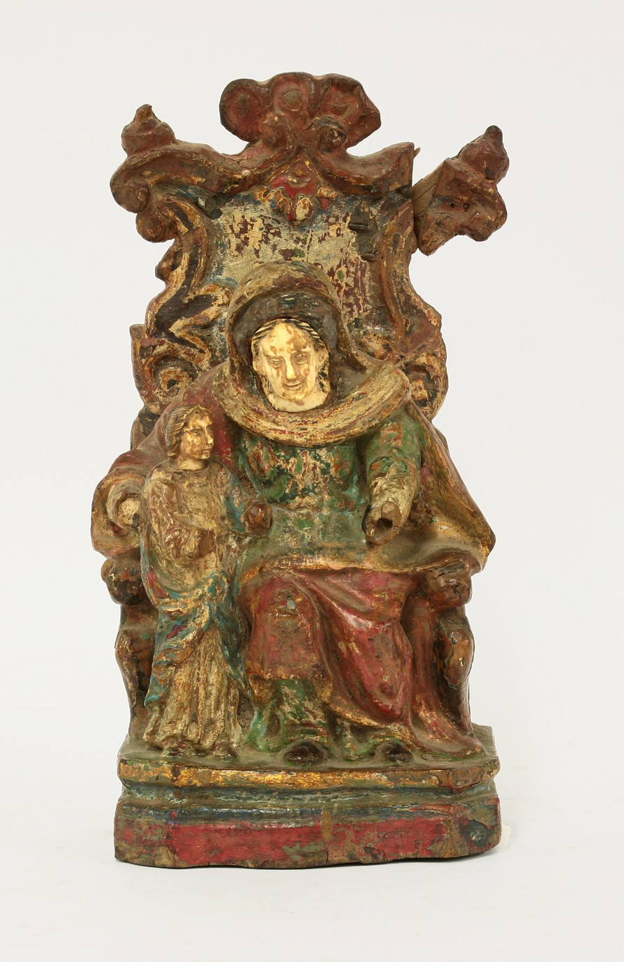 A Spanish polychrome carving,
17th century, probably depicting Mary and Jesus, she sitting in a
