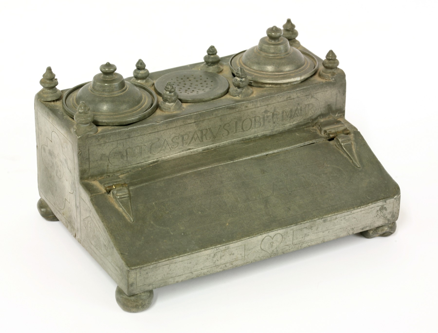 A Continental pewter desk stand,
dated 1723, of usual form with two inkwells flanking a pounce