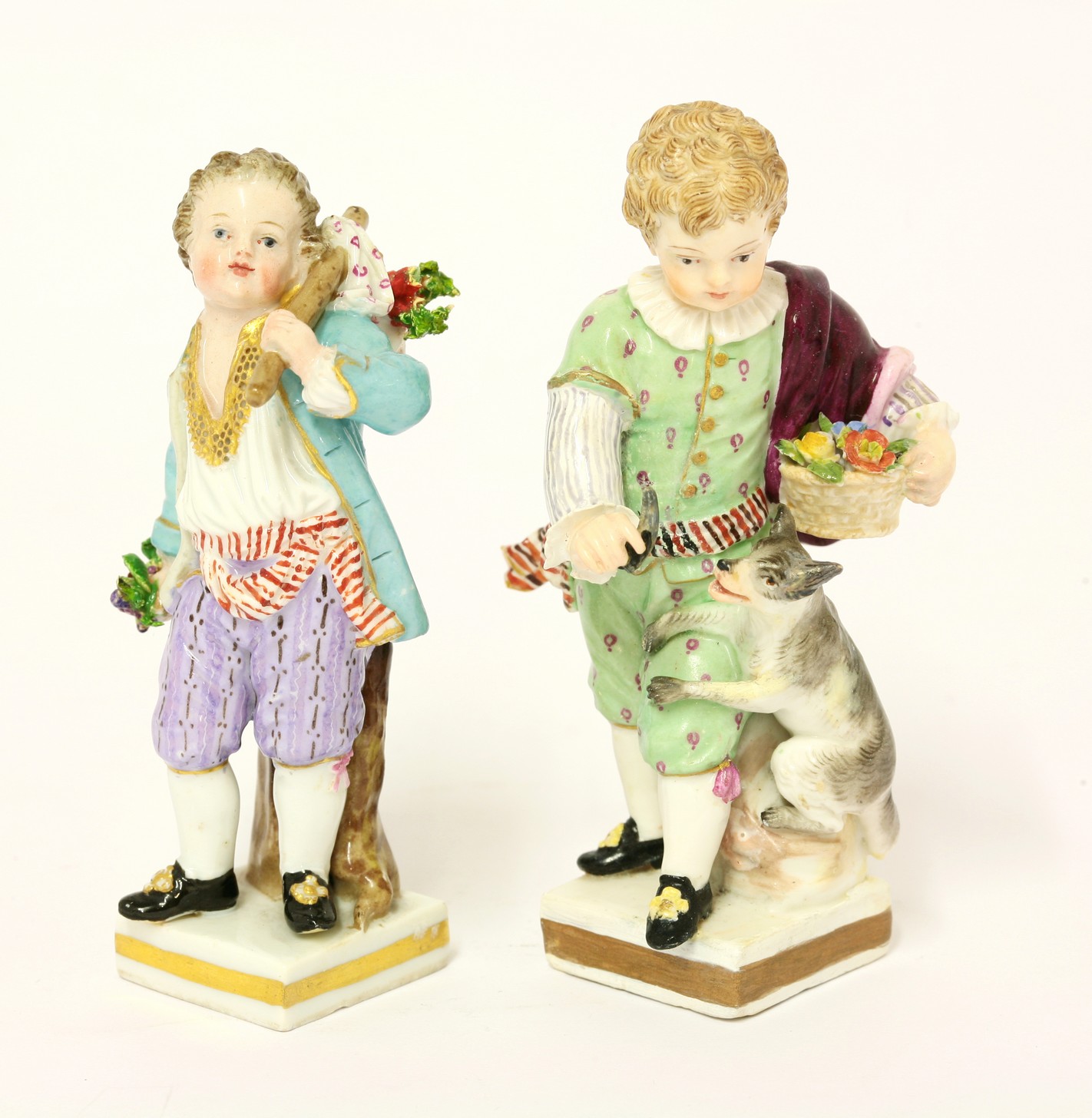 Two Meissen Figures,
mid 19th century, of boys, one with a dog on a rock, the other shouldering