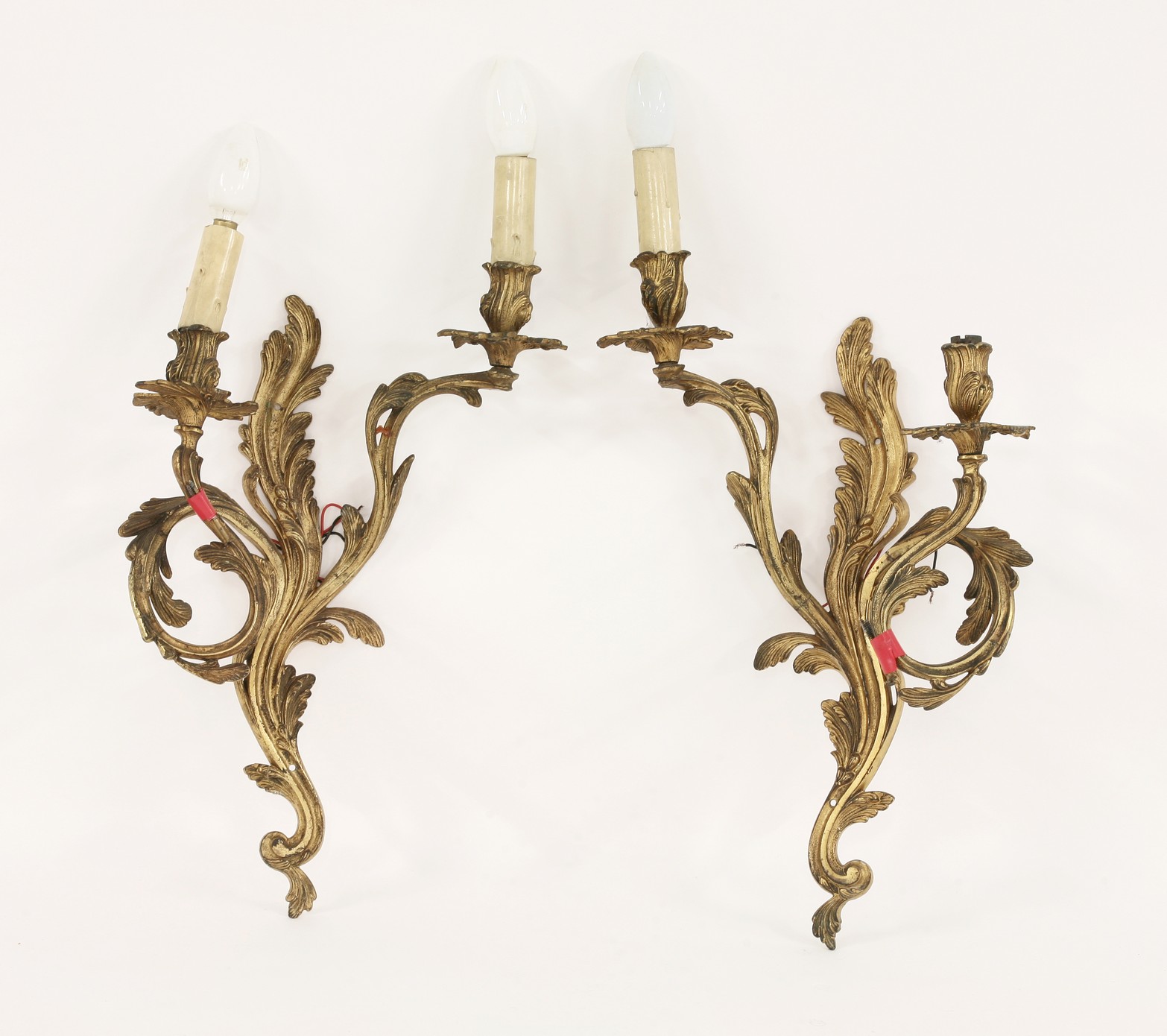 A pair of gilt bronze two-branch wall lamps,
49cm high CONDITION REPORT: Wear to gilding.