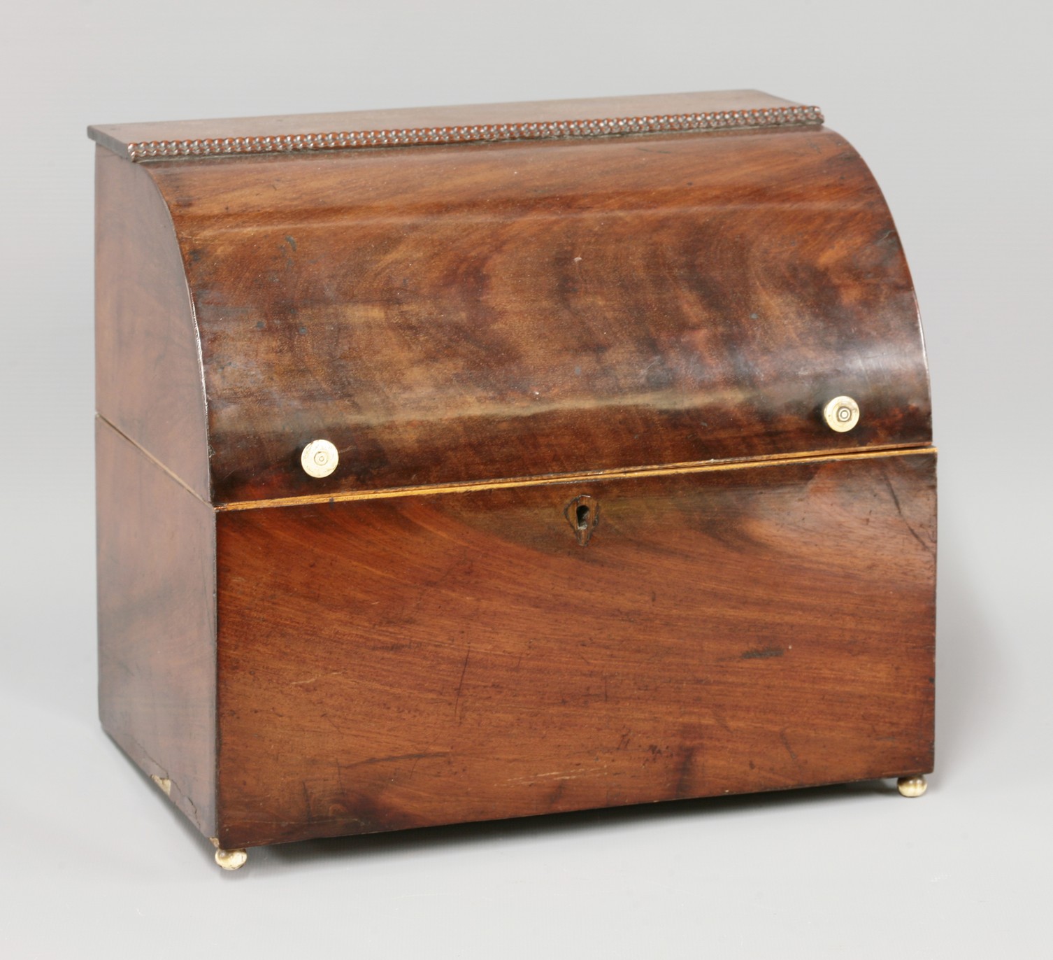 A mahogany liqueur cabinet,
19th century, with a curved hinged lid, fitted with six square decanters