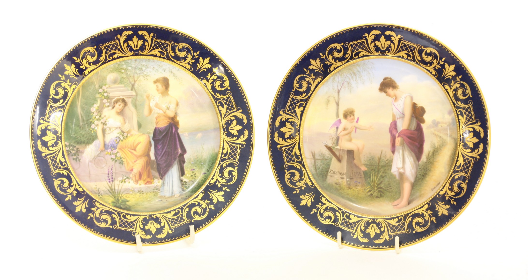 A pair of Vienna Plates,
c.1900, each painted within a red printed outline with named figures of