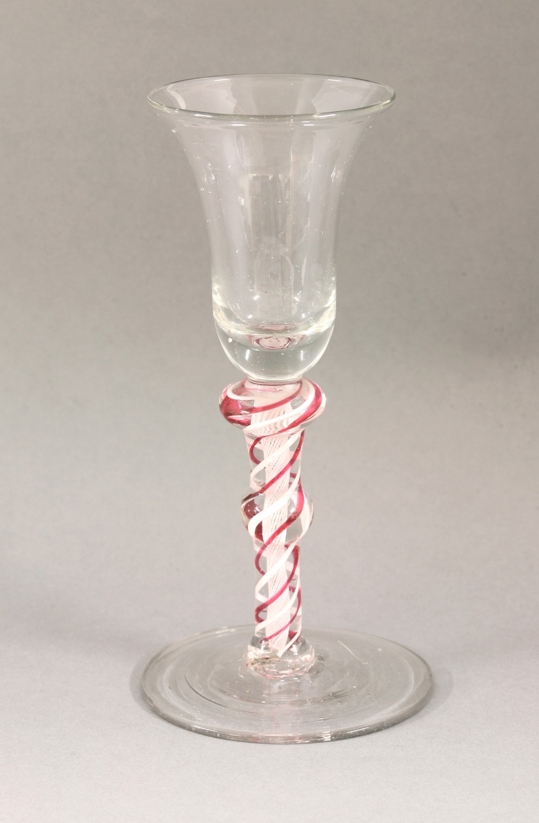 A Georgian Wine Glass,
c.1780, the bell bowl on double knopped white and red twist stem,
15.3cm high