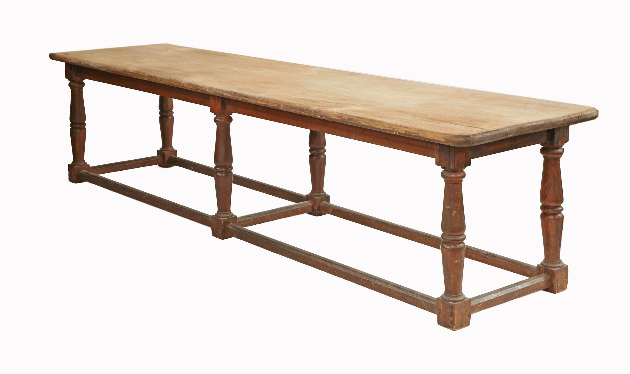 A large Victorian scrubbed pine kitchen table,
the three plank top raised on a pitch pine baluster