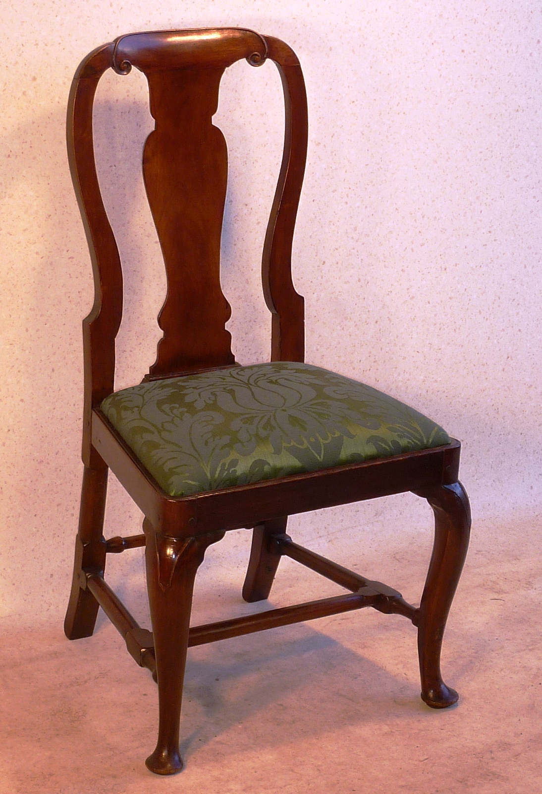 A Queen Anne walnut Side Chair with a vase shaped back splat standing on cabriole legs with