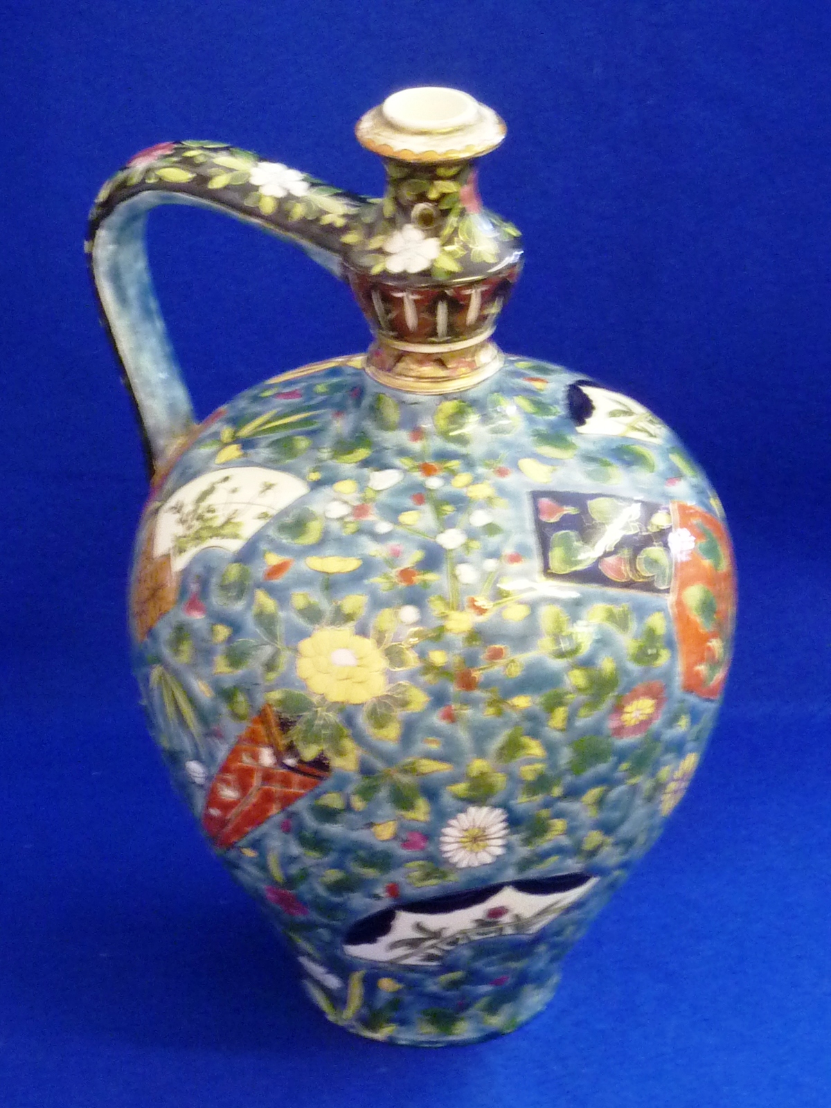 A late 19th Century Ignace Fischer (Budapest) polychrome and gilt pottery Jug decorated in an