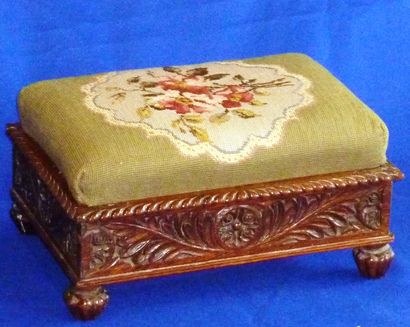 A late Regency period solid rosewood Footstool, the gros point drop-in floral (later) needlework