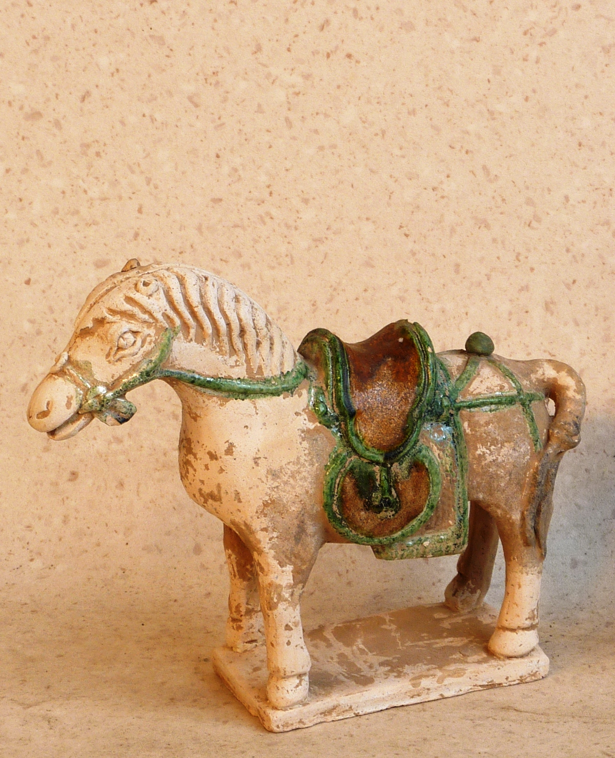 Ming Dynasty (1368-1644AD), a pottery Horse with long saddle, standing foursquare on rectangular